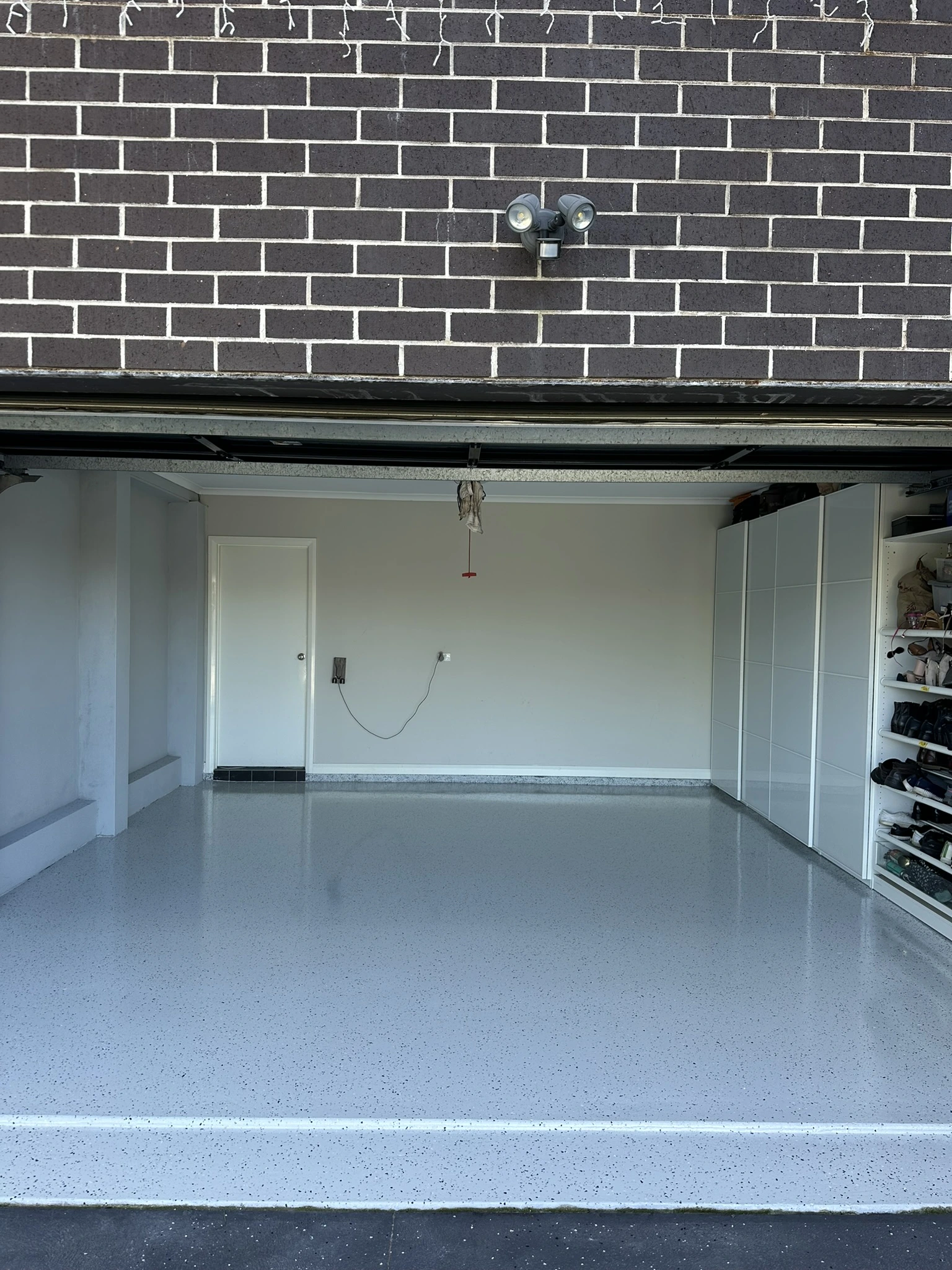 Light grey flake epoxy garage floor with built-in storage