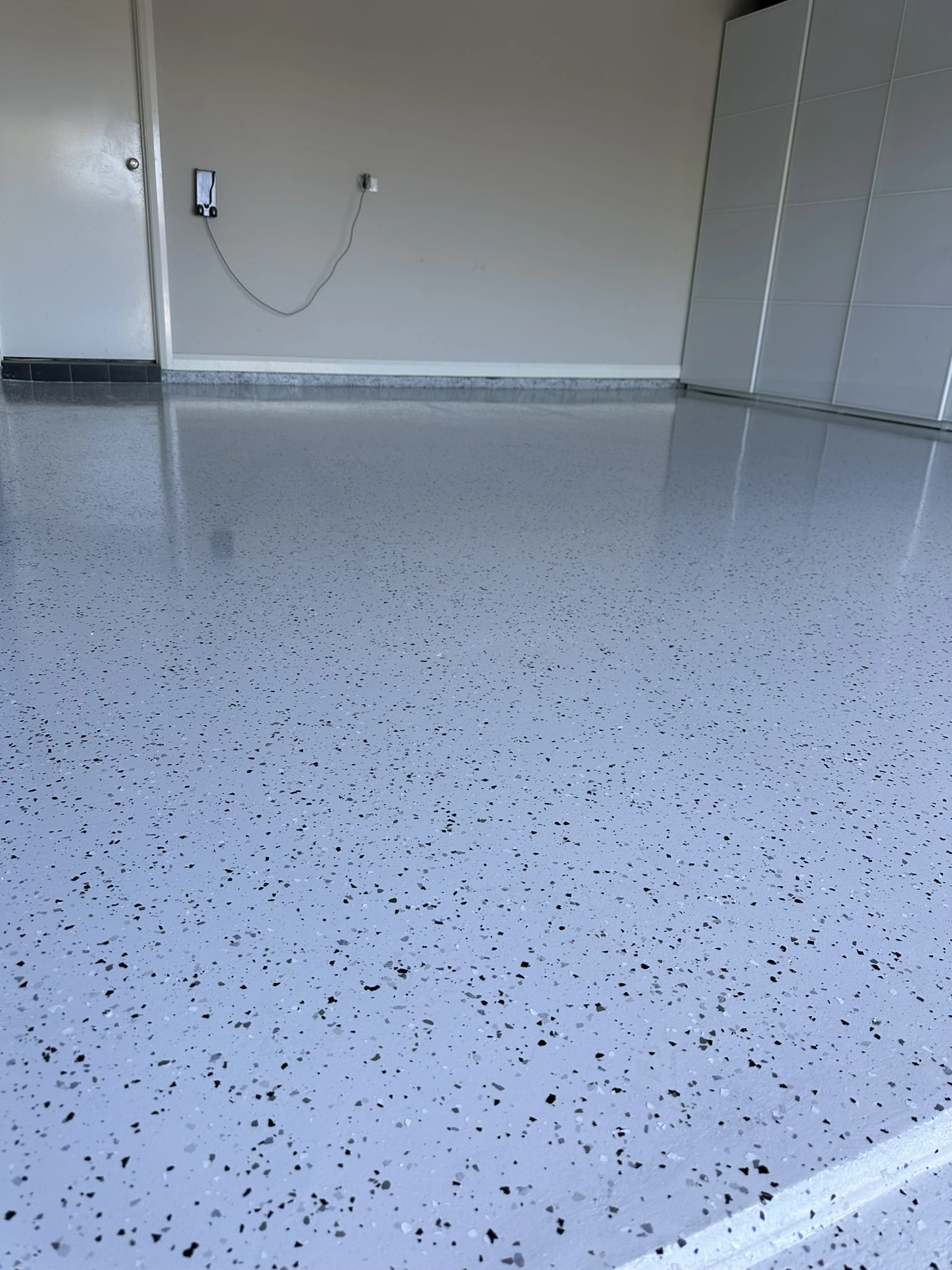 Close view of grey flake epoxy with black and white chips