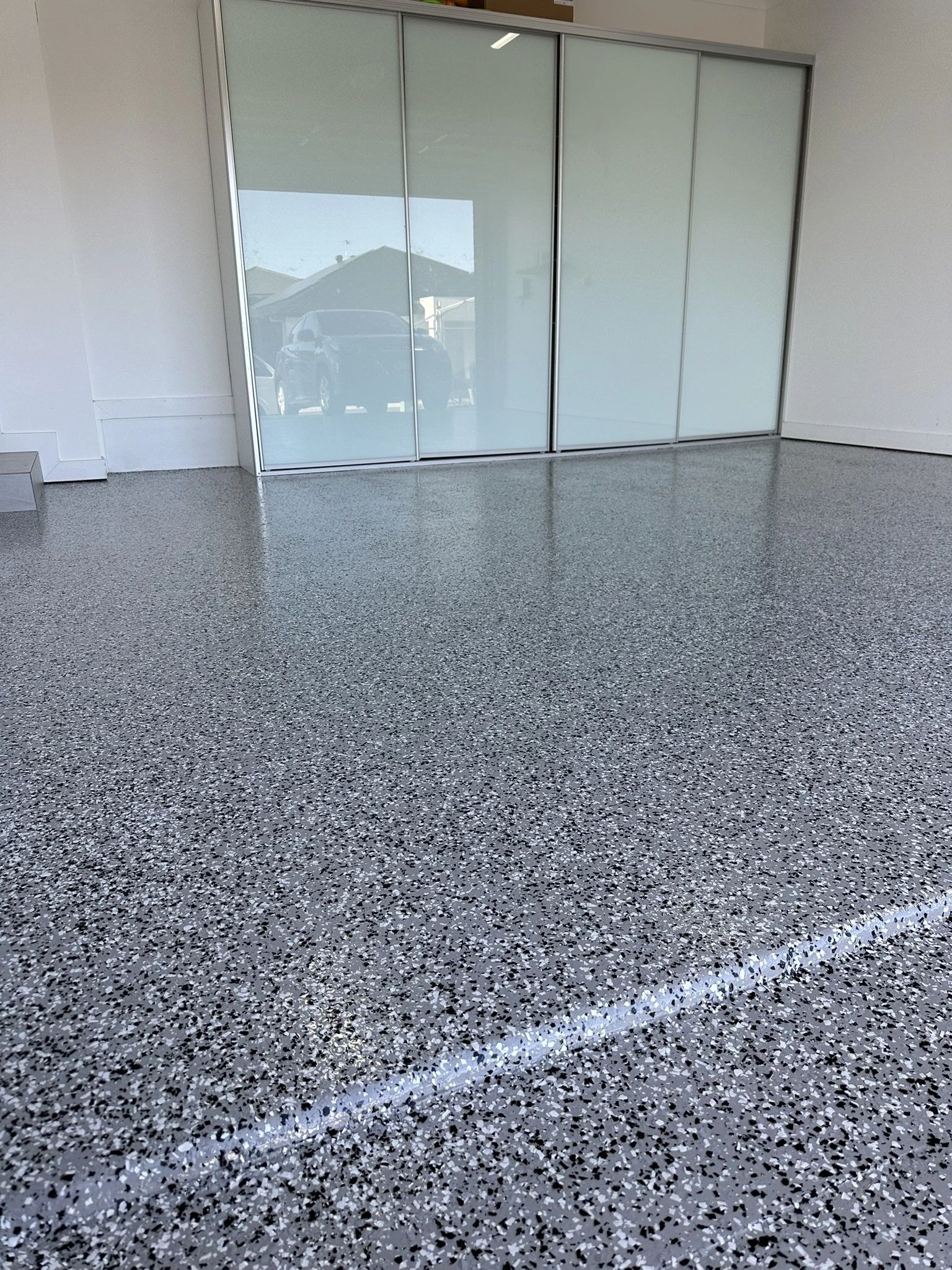 Flake epoxy floor reflecting daylight