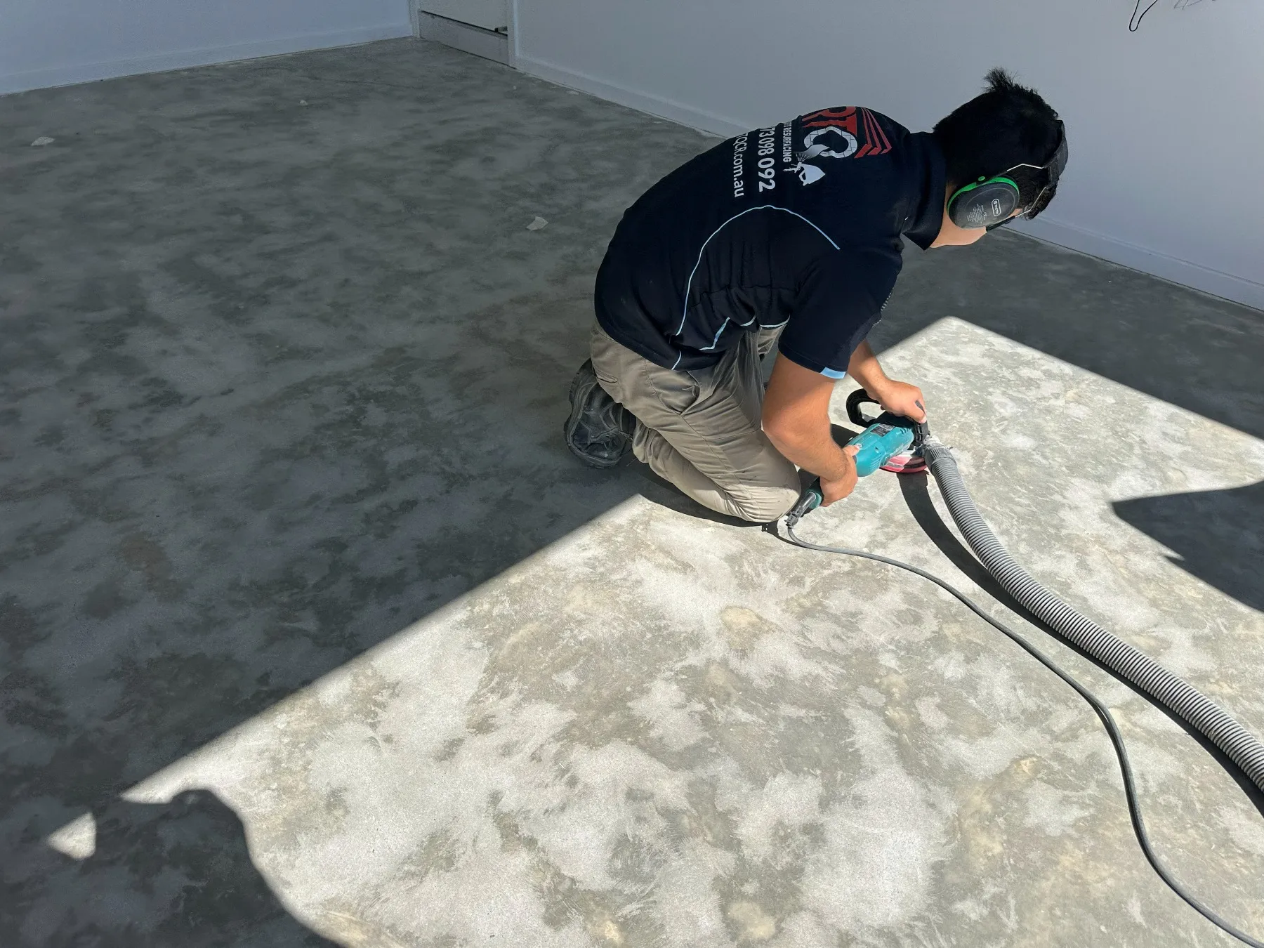 RTQ team member diamond grinding a concrete garage slab