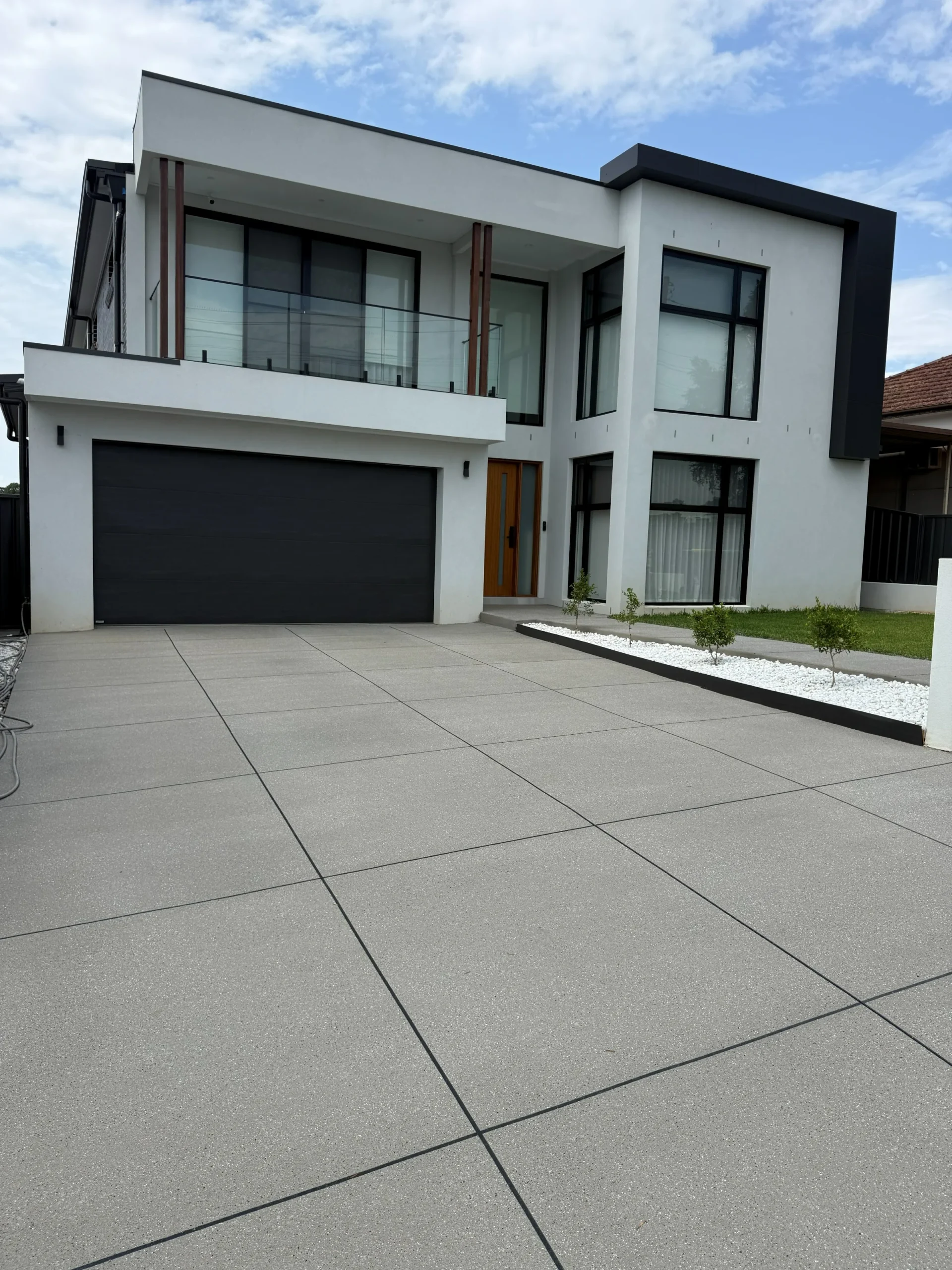 Modern two-storey home in St Marys with a Silver Sands tile-box spray-crete driveway