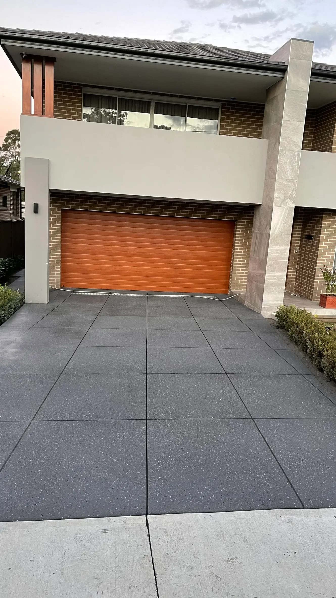 Slate Grey spray-crete driveway with tile-box pattern in Wentworthville