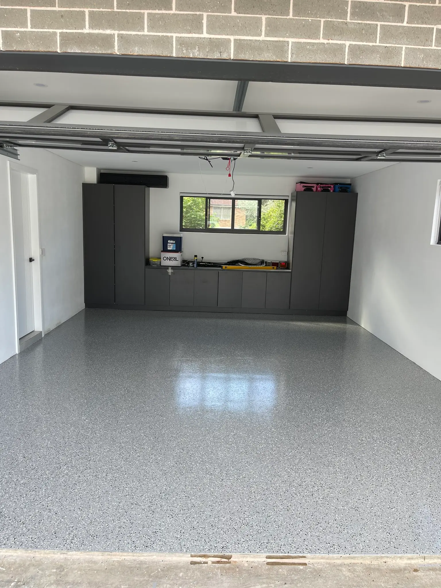 Partial flake epoxy garage floor with Koala Grey base and cabinets in Belmore