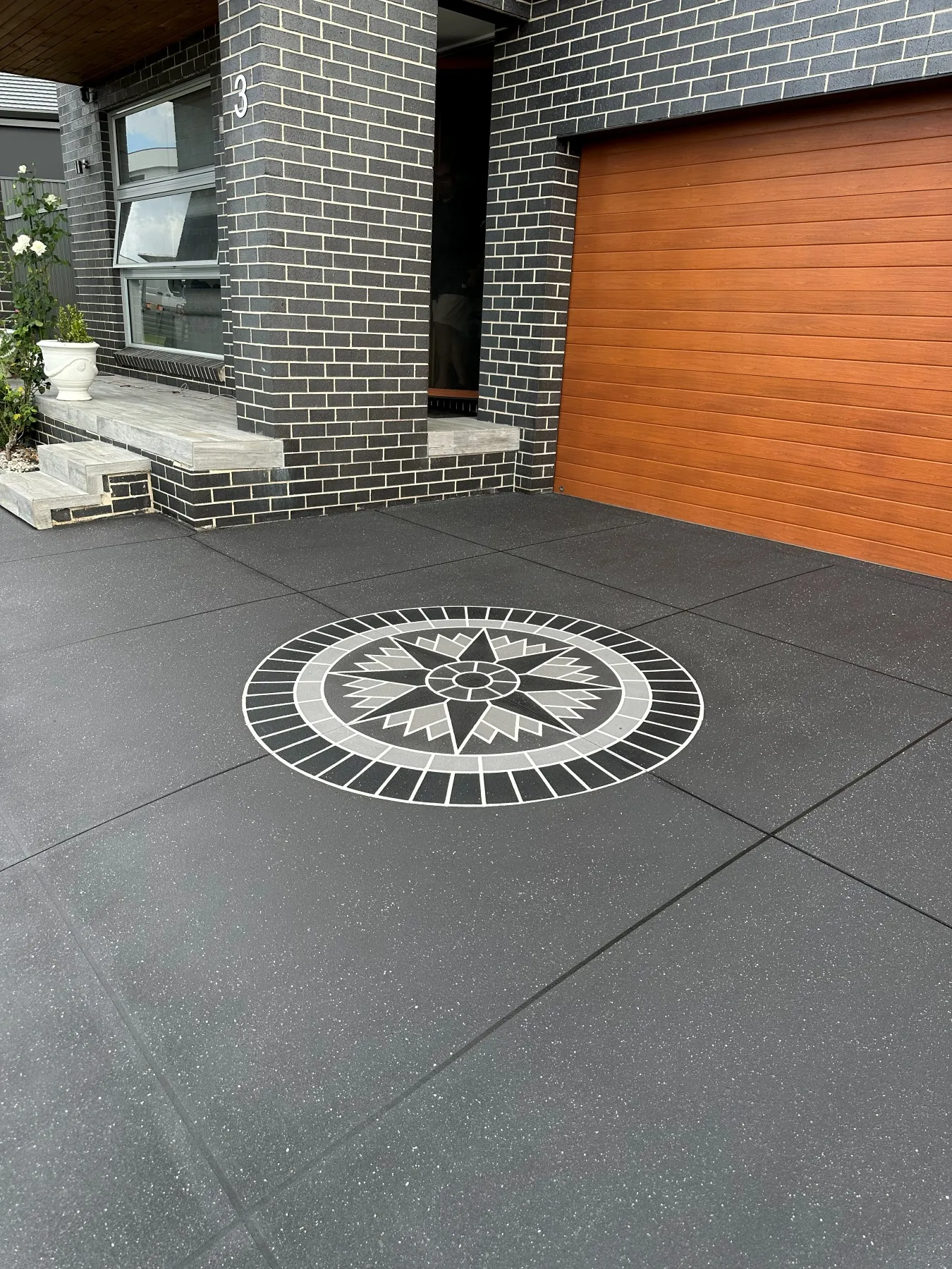 GunMetal spray-crete driveway with star compass feature in Leppington