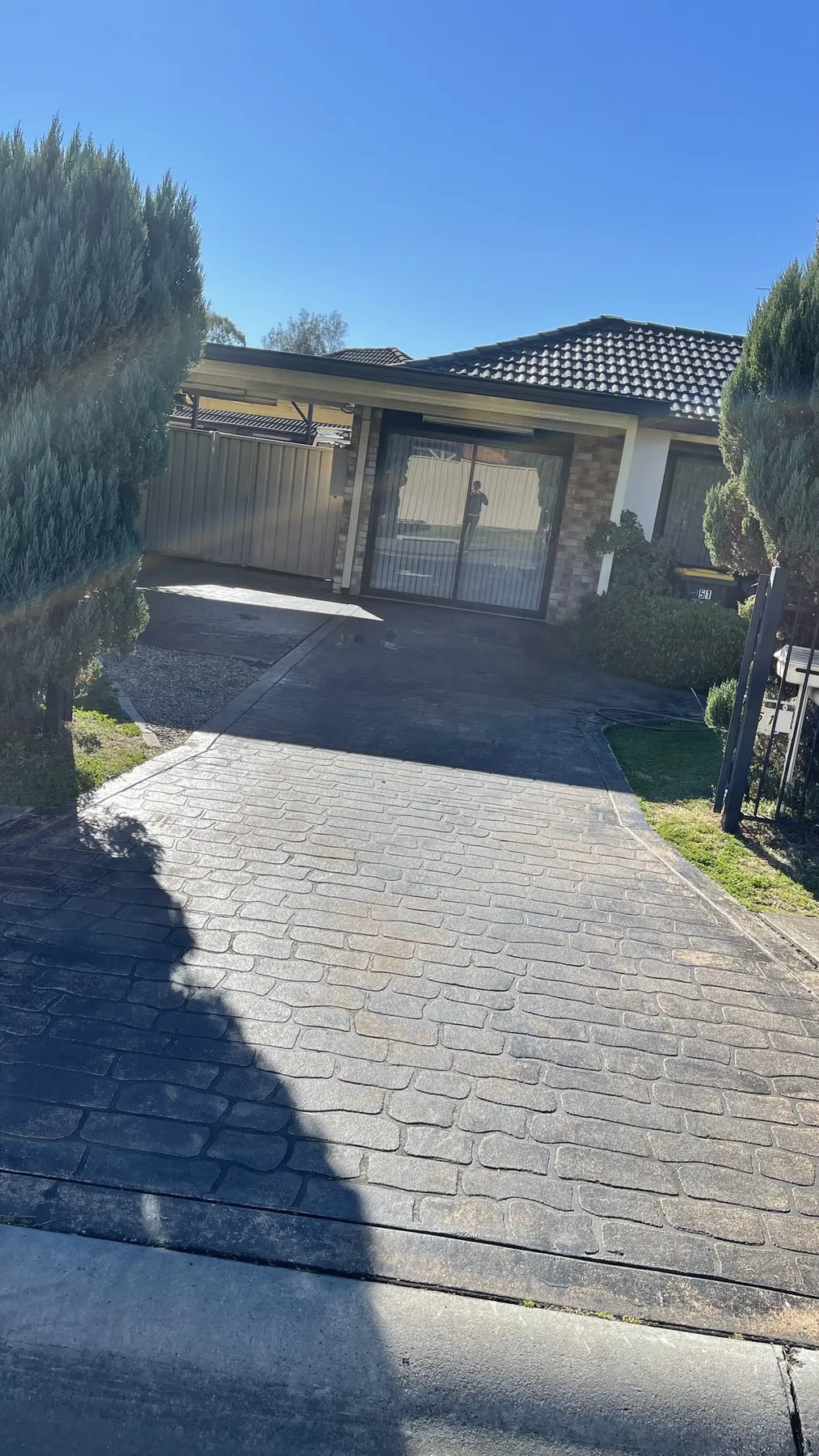 Faded stencilled driveway before colour sealing