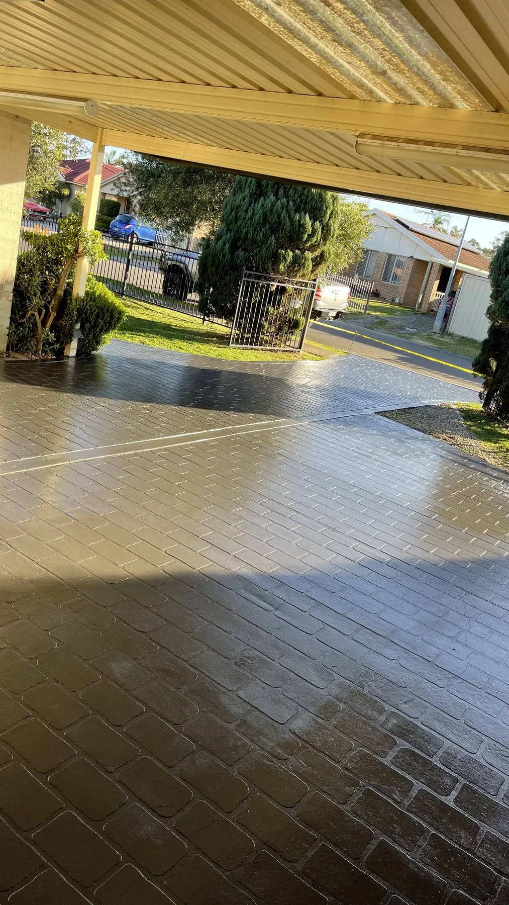 Cobble-pattern carport after colour sealing with a gloss finish
