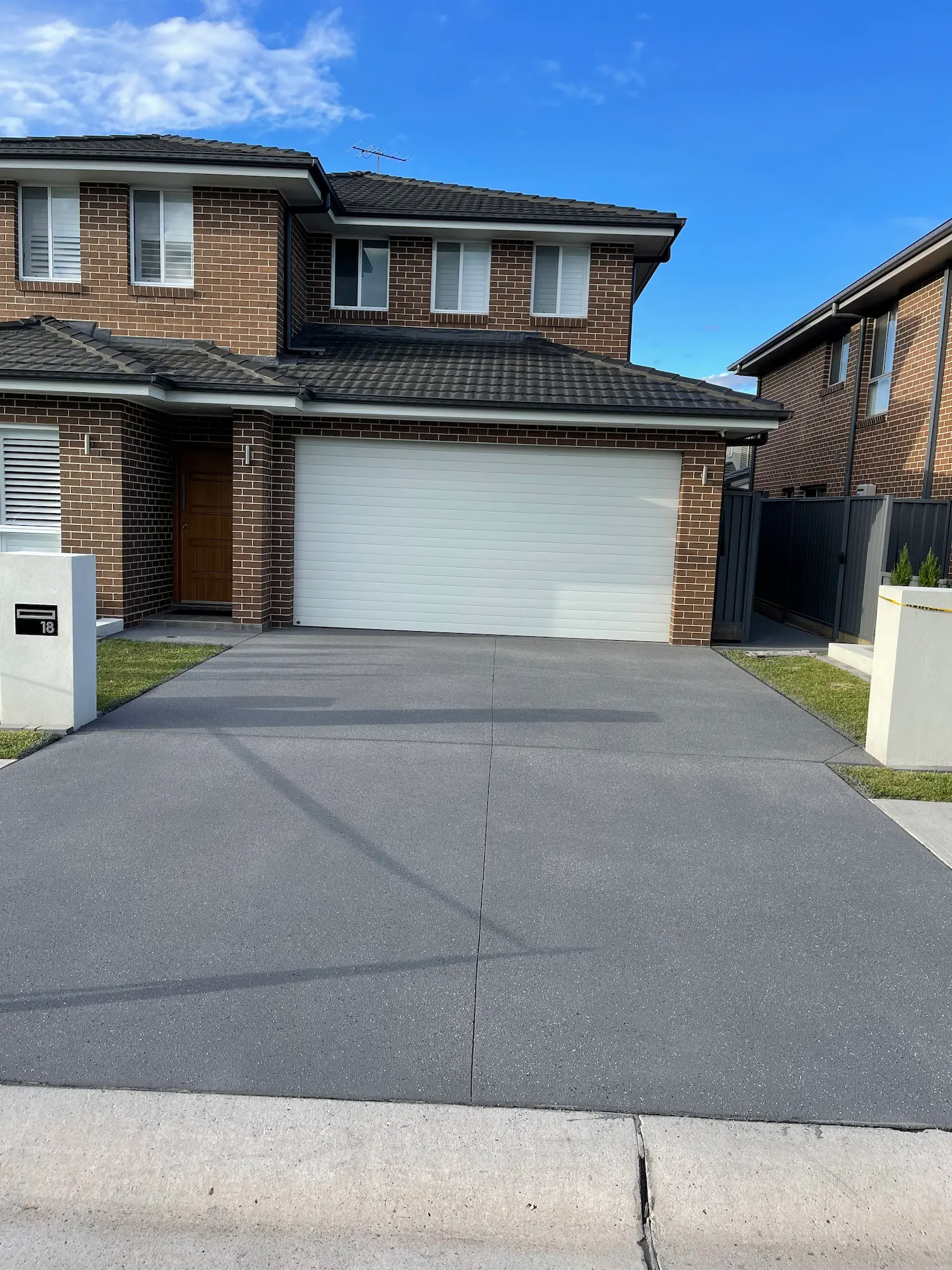 Dark spray-crete driveway with box pattern